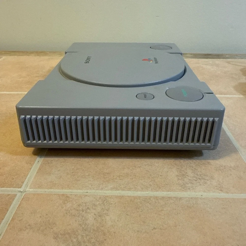 Sony Gray PlayStation Console with Two Wired Gray Controllers